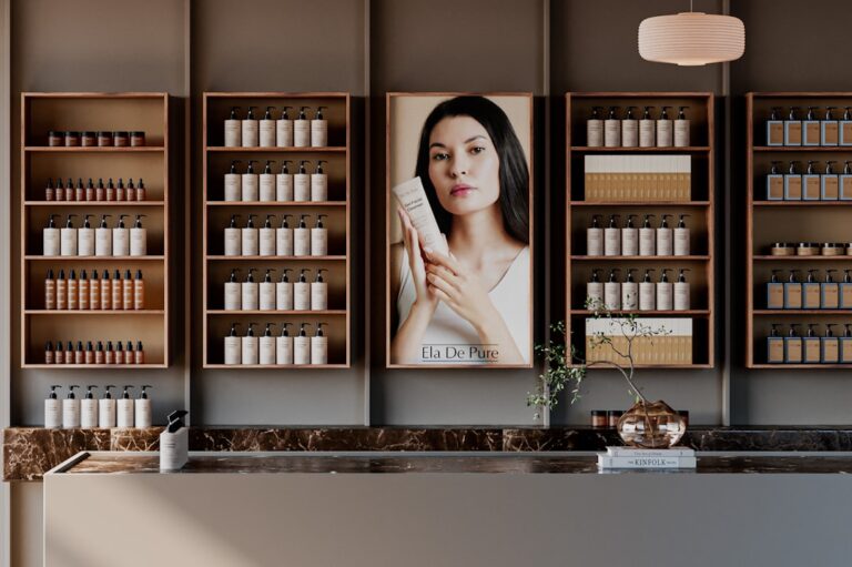 Three unbranded glass jars of lotion, leafy plants, and a handwritten ingredient list on a kitchen table.